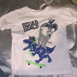 A white shirt with dinosaurs